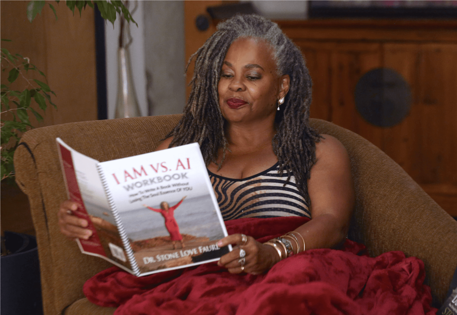 Image20250312054954 A woman sitting on the couch reading a book.