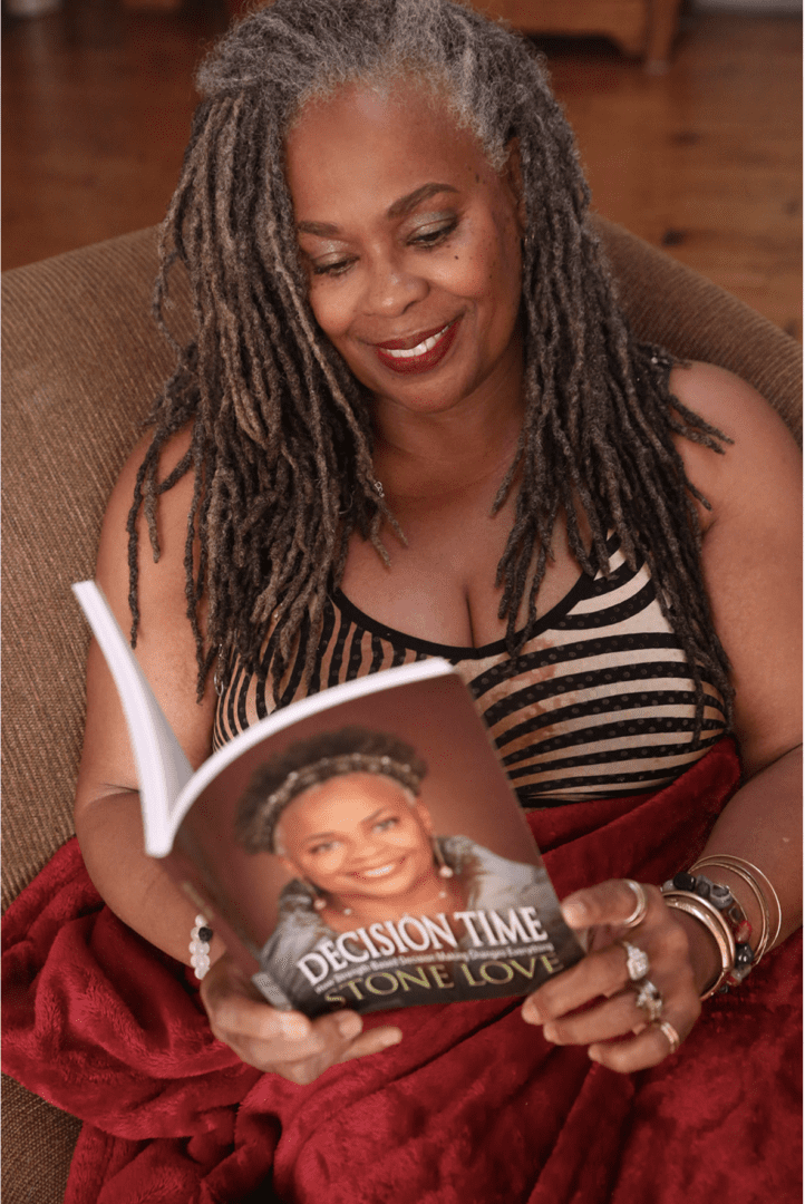 Image20250312060743 A woman sitting on the couch reading a book.