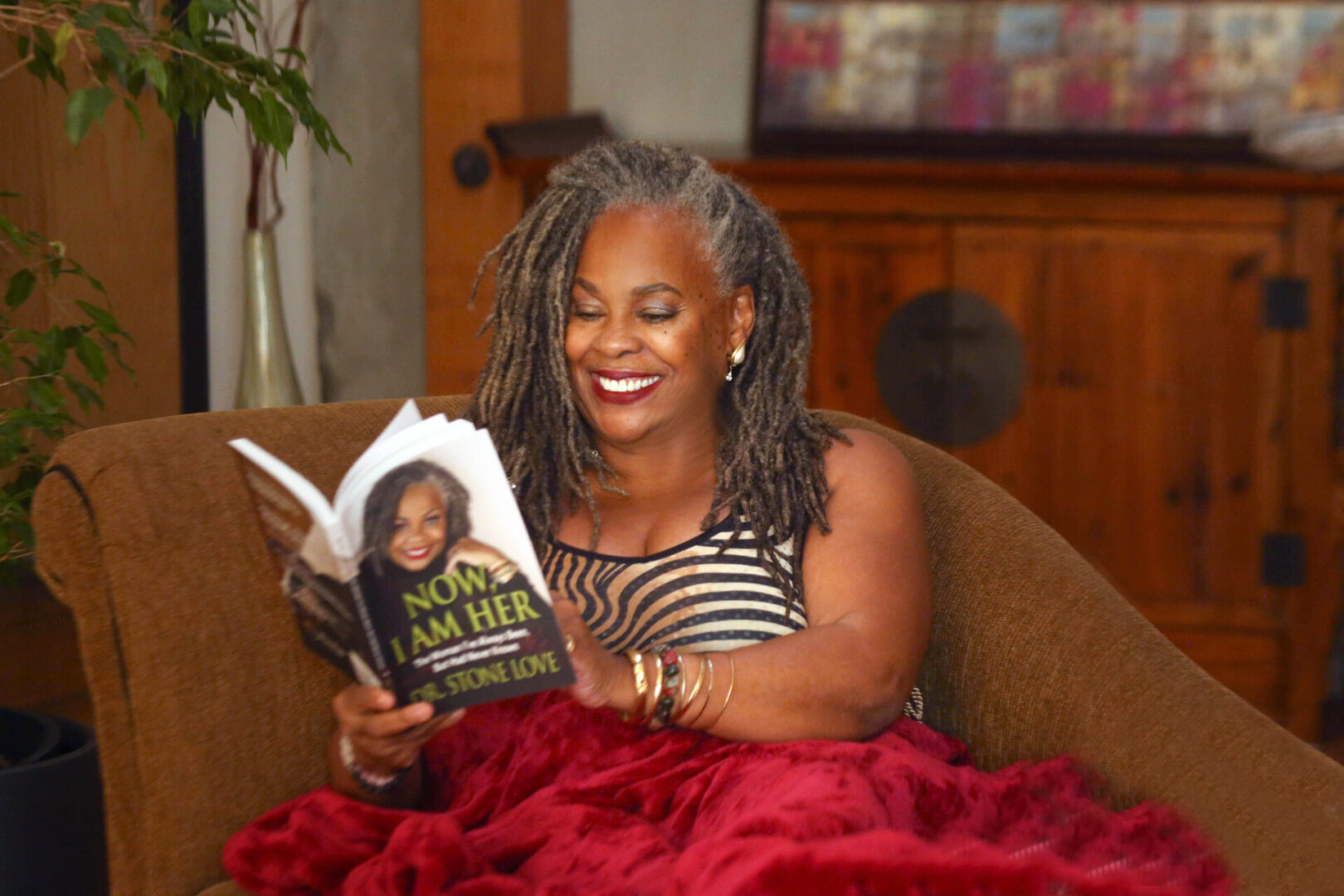 Image20250312060945 A woman sitting in a chair reading a book.